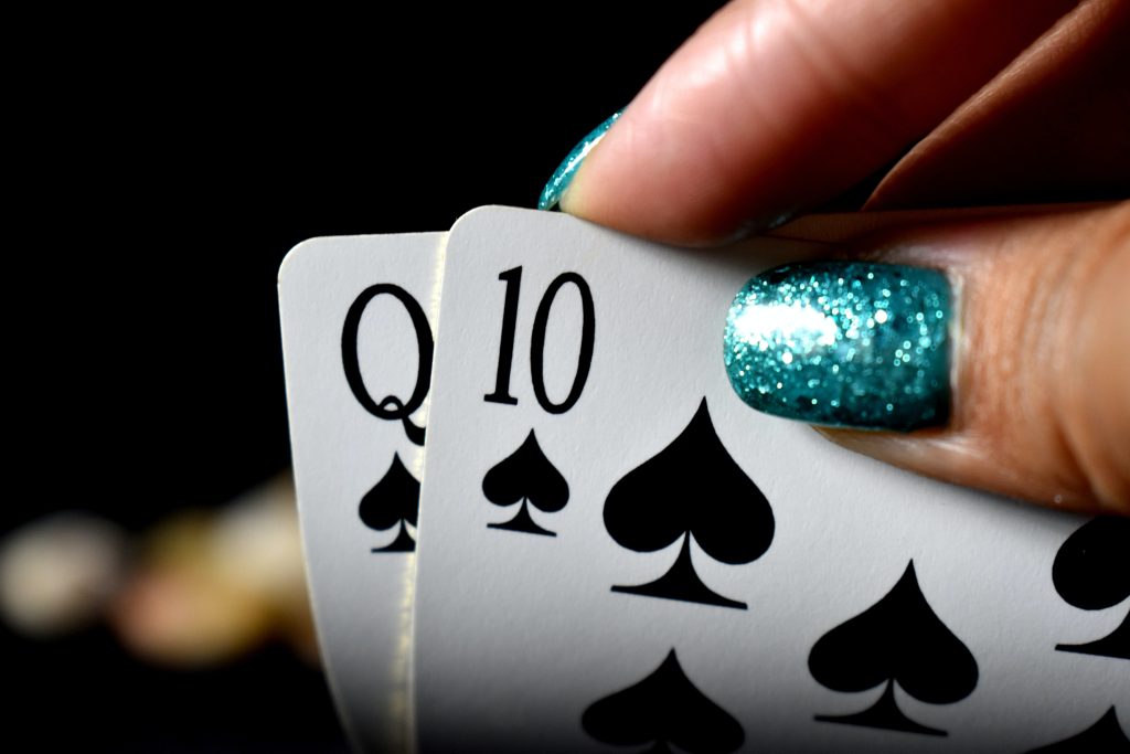 female hands showing poker cards