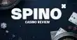 Spino casino review banner with roulette wheels, playing cards and poker chips on a dark blue casino-themed background.